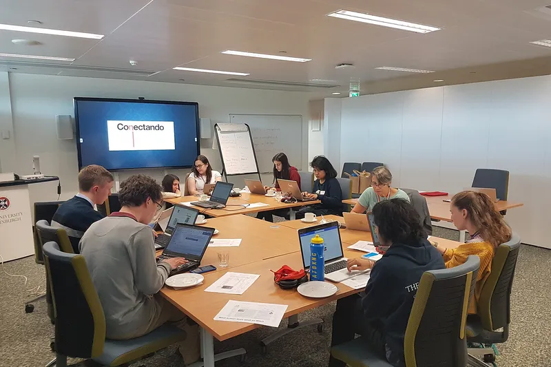 Postgraduate students working around a seminar table